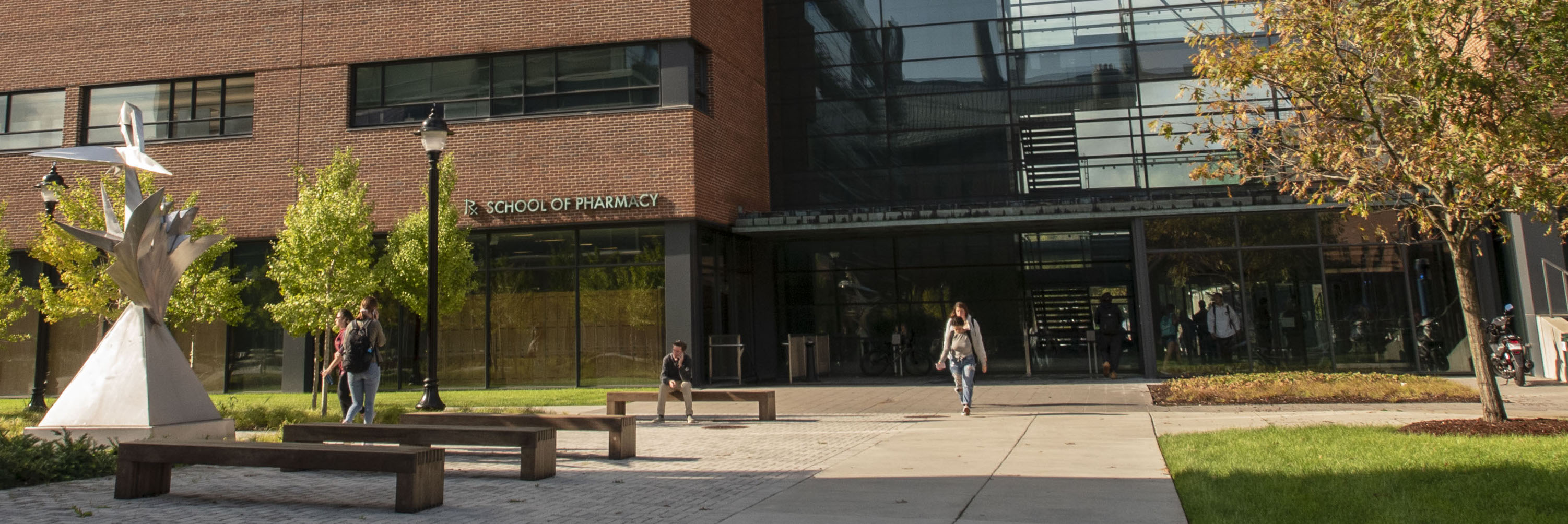 Students walking to and from the School of Pharmacy building