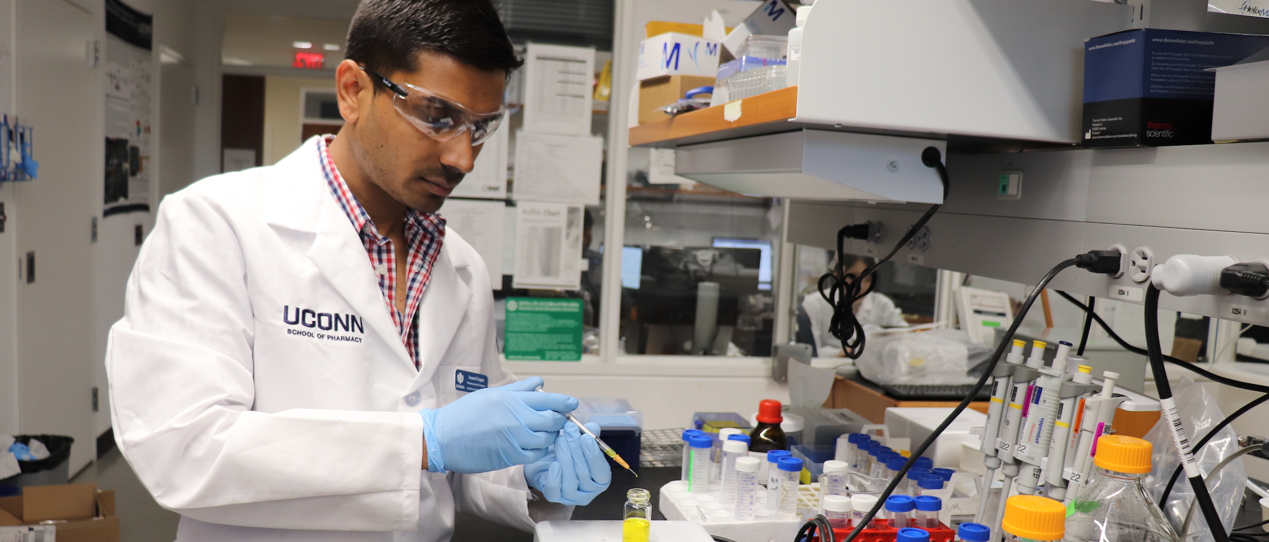 A Ph.D. candidate works in the lab