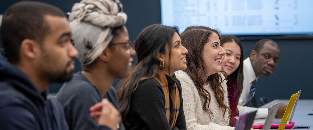 UConn Pharmacy students listen to a lecture in a classroom
